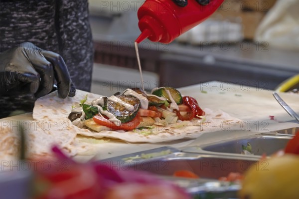 Preparation of falafel with vegetables and mayonnaise at a stand in the pedestrian zone, Nuremberg, Middle Franconia, Bavaria, Germany