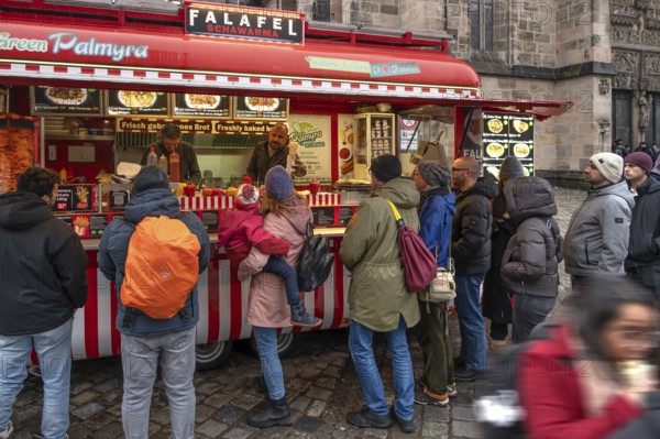 People waiting at the falafel stand in front of St. Lorenz Church, Nuremberg, Middle Franconia, Bavaria, Germany