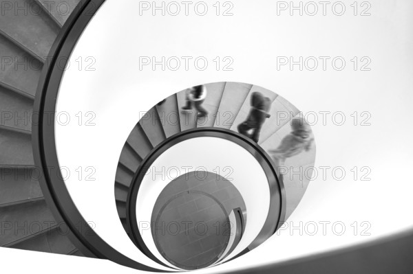 People walking downhill on a spiral staircase, movement, black and white, Nuremberg, Middle Franconia, Bavaria, Germany