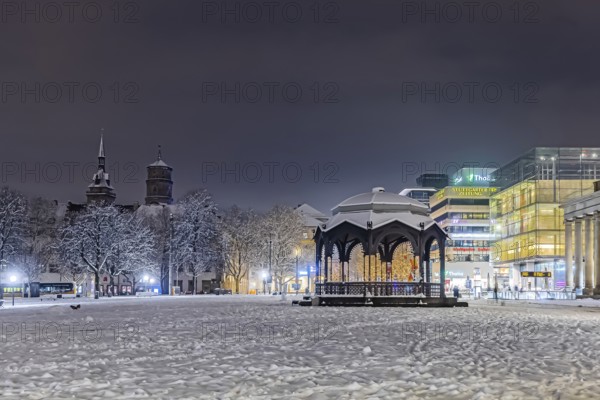Winter in Stuttgart. It snowed overnight and the city is wintry white early in the morning. Palace Square with bandstand, collegiate church and art museum. Stuttgart, Baden-Württemberg, Germany