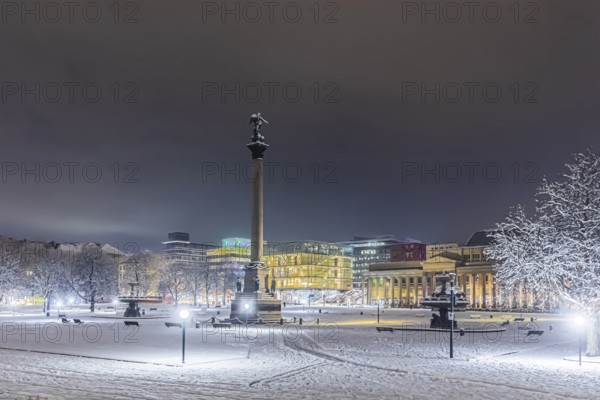 Winter in Stuttgart. It snowed overnight and the city is wintry white early in the morning. Palace Square with Jubilee Column and Royal Building. Stuttgart, Baden-Württemberg, Germany