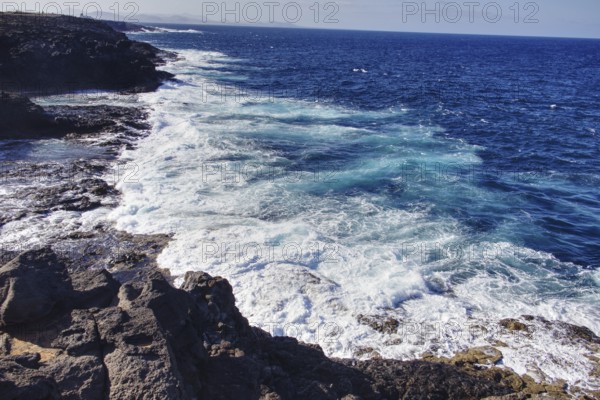Stormy sea with breaking waves beating against the rocky coast, Playa Blanca Lanzarote