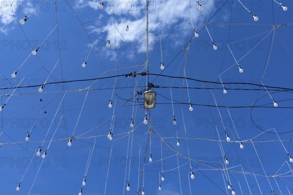 Light bulbs for evening lighting against blue sky, Cluj-Napoca, Transylvania, Romania