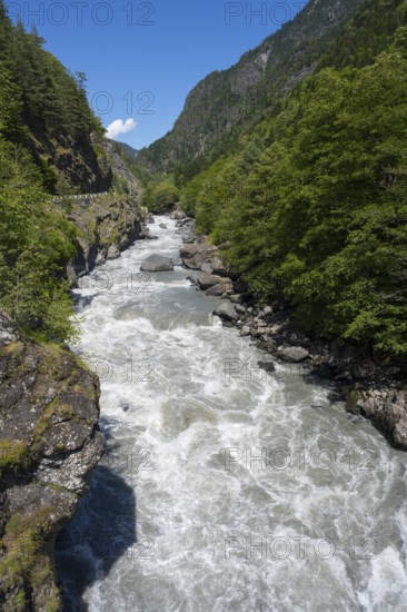 Wild flowing river in a mountainous, wooded landscape under blue sky, Enguri River near Khaishi, Mingrelia and Upper Svaneti region, Georgia