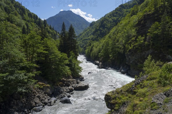 A picturesque river snakes through a wooded valley, Enguri River near Khaishi, Mingrelia region and Upper Svaneti, Georgia