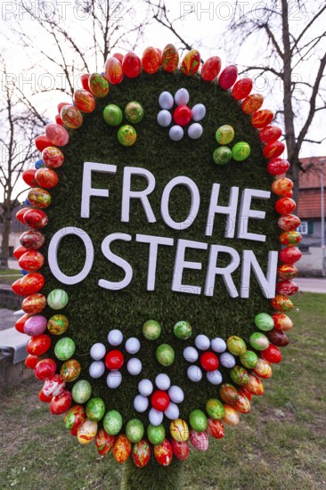 29.03.2018: Festive Easter decoration featuring colorful eggs and egg shape. Faurndau, Goeppingen, Baden-Wuerttemberg, Germany
