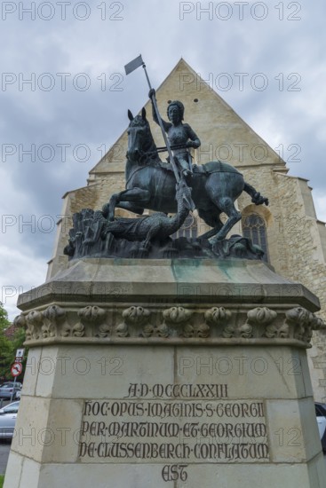 Sculpture of Saint George with dragons, in the back the Reformed Church in Wolfsgasse, Cluj-Napoca, Transylvania, Romania
