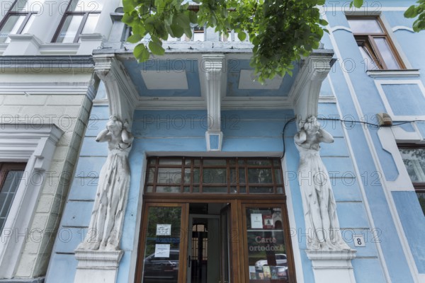 Caryatids under a balcony of a 19th century house, Cluj-Napoca, Transylvania, Romania