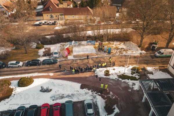 People standing in a wintry environment with cable drums, from a drone perspective, fiberglass groundbreaking, Freudenstadt, Germany