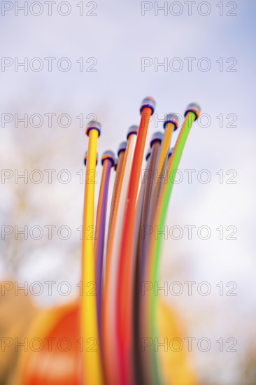 Close-up of colorful cables rising into the sky in sunshine, fiberglass groundbreaking, Freudenstadt, Germany
