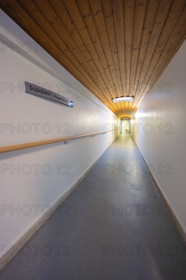 Long corridor with wooden ceiling and sign, soft lighting, fibreglass groundbreaking, Freudenstadt, Germany