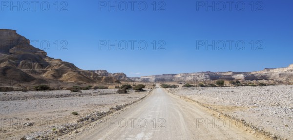 Sand track leads through the limestone gorge of Wadi Shuwaymiyah, Dhofar, Oman