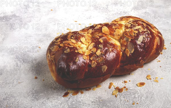 Braided, sweet bread pie, with sliced almonds, breakfast, braided bread, brioche, on a light background, top view, no people
