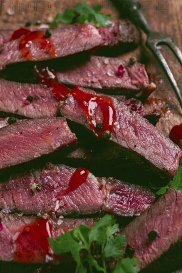 Fried steak, beef steak, rib eye steak, sliced steak, on a chopping board, top view, no people