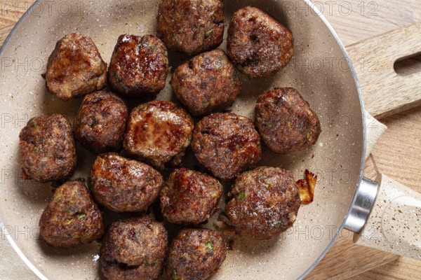 Fried meatballs in a frying pan, homemade, no people