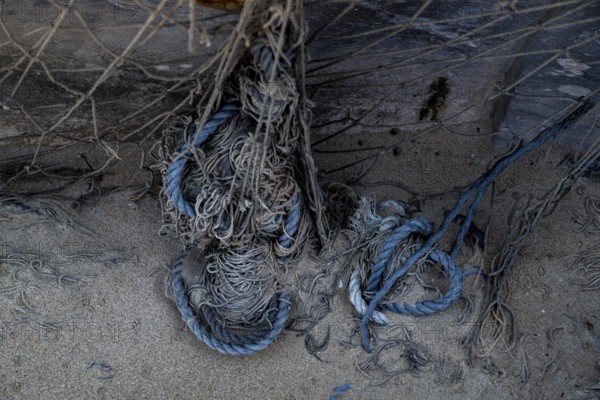Close-up view of old fishing net hanging on boat, Oman