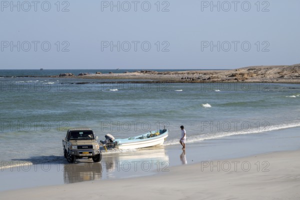 Car pulls fishing boat into sea, Oman