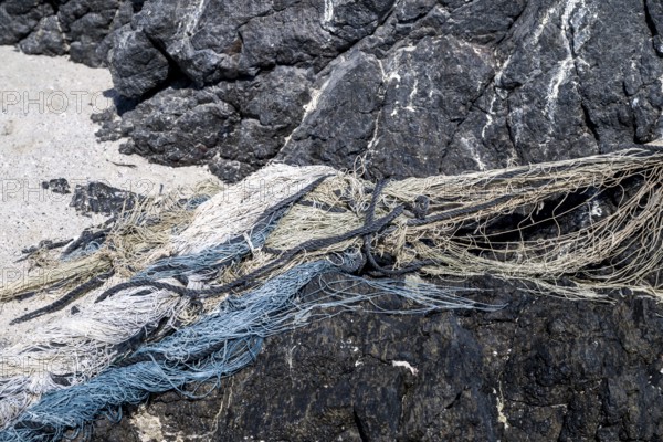 Close-up view of old fishing nets lying on the beach, Oman