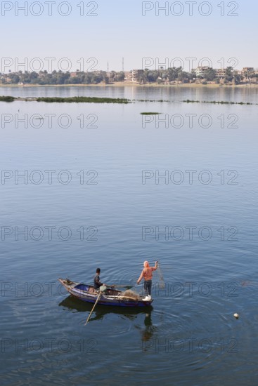 Boys in a rowboat fishing on the Nile, Luxor, Egypt