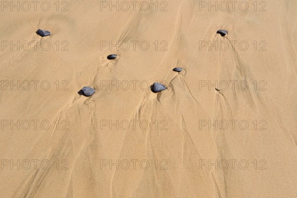 Rocks on sandy beach, Algarve, Portugal