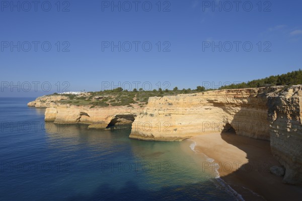 Cliff with caves and beach, Praia da Corredoura, Algarve, Portugal