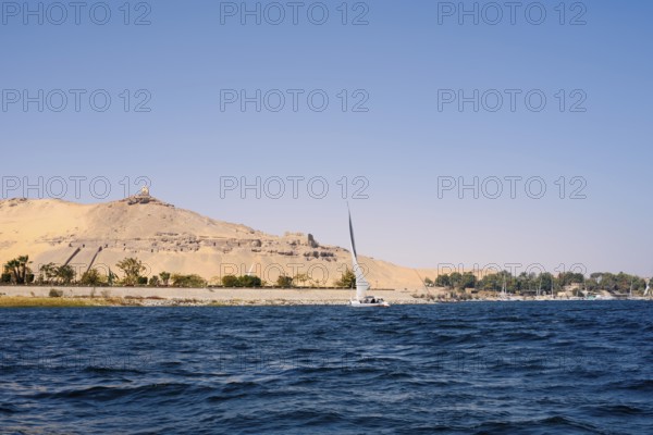Qubbet el-Hawa with the rock tombs on the Nile, Aswan, Egypt