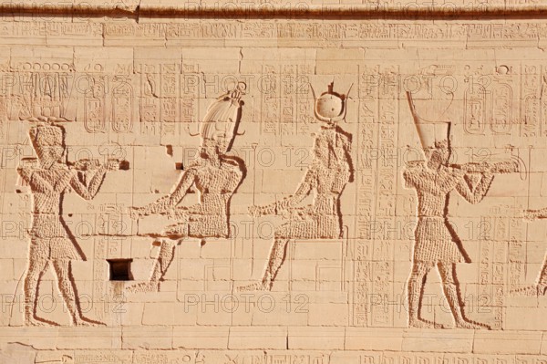 Relief of the king in front of the gods Osiris and Isis, Temple of Philae, UNESCO World Heritage Site, Agilkia Island, Aswan, Nubia, Egypt