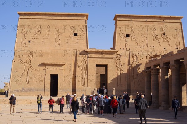 Tourists on the square in front of the first pylon, Isis temple, Philae temple, UNESCO World Heritage Site, Agilkia island, Aswan, Nubia, Egypt