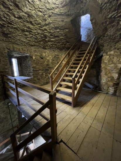 Modern wooden staircase for visitors tourists in keep made of quarry stone masonry Castle tower of castle ruins of medieval hill castle Reifferscheid tourist destination in Eifel, Reifferscheid, Hellenthal, Euskirchen district, North Rhine-Westphalia, Germany