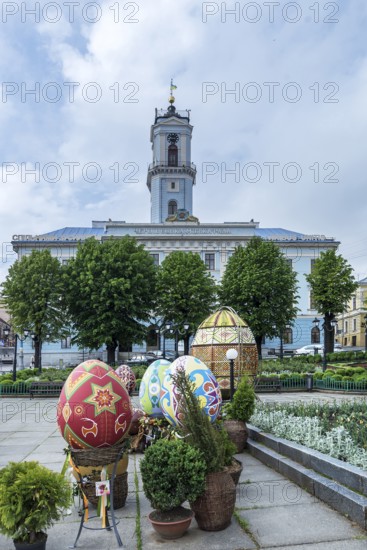 Traditionally painted and embroidered Easter eggs, Czernowicz, Ukraine in the back the town hall, Chernivtsi, Ukraine