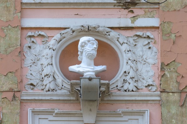 Male bust on a dilapidated 19th century house façade, Czernowicz, Ukraine