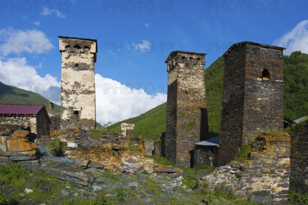Stone towers in a historic village under clear blue sky in a hilly landscape, defensive towers, Ushguli, Murqmeli district, Upper Svaneti, Svaneti, Georgia