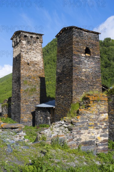Two restored stone towers surrounded by nature and blue skies, defensive towers, Ushguli, Murqmeli district, Upper Svaneti, Svaneti, Georgia