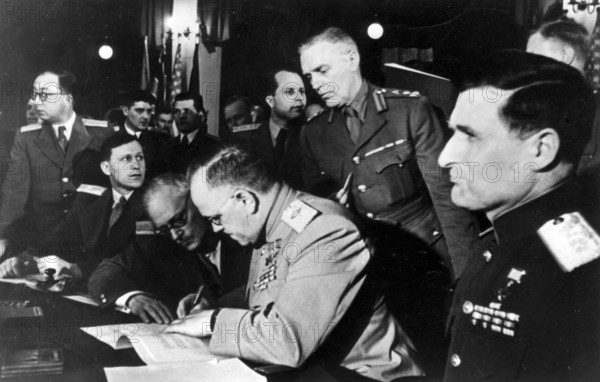 Signing of the unconditional surrender of the fascist German Wehrmacht on May 8, 1945 in Berlin - Karlshorst. As representative of the High Command of the Red Army, Marshal of the Soviet Union G. K. Zhukov signs the surrender document, on the left the Deputy Soviet Foreign Minister A. J. Vyshinsky, on the right Army General V.D. Sokolovsky