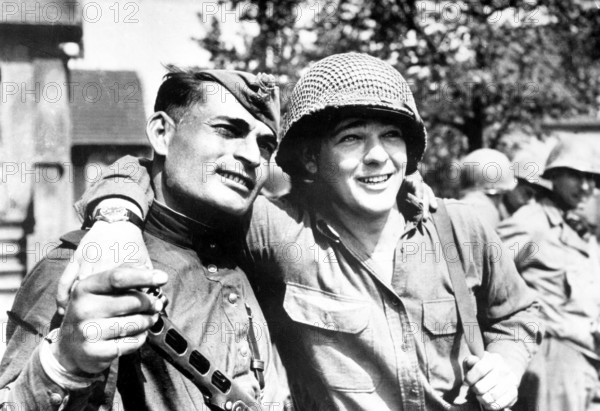 An American and a Russian soldier from Azerbaijan hug each other. Berlin in July 1945