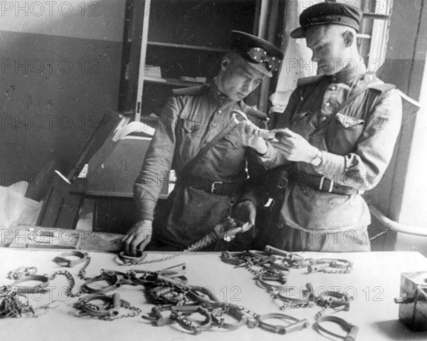 Soviet soldiers in the Gestapo building, handcuffs, May 1945, Berlin, Germany