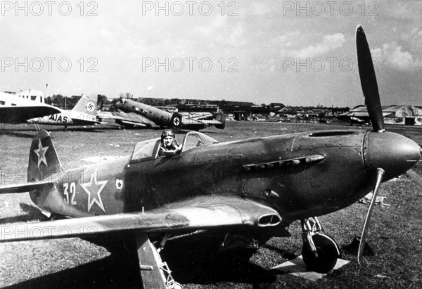 Soviet pilot with plane at Tempelhof Airport in Berlin May, 1945, Germany