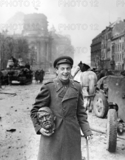 The poet Yevgeny Aronovich Dolmatowski with a Hitler's head as a trophy, Brandenburg Gate, Berlin on May 2, 1945