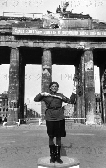 Soviet traffic police officer regulates traffic in front of the Brandenburg Gate, June 1945, Germany