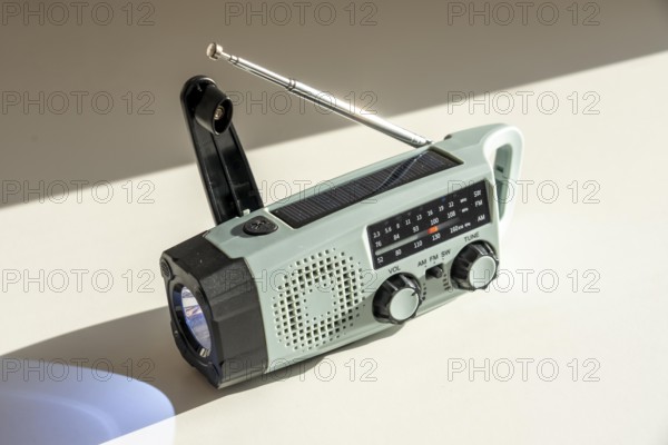 Radio with crank mode, by turning the crank we generate electricity in a dynamo, which charges a battery in a flashlight, in addition a small solar module to generate electricity from sunlight, for emergency preparedness in the event of a power failure, blackout, energy supply