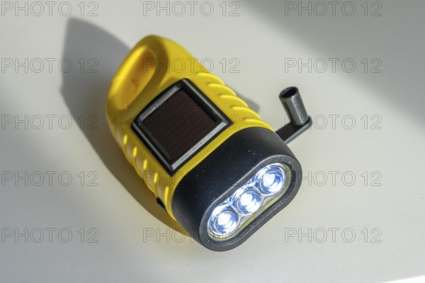 Crank operated flashlight, by turning the crank, we generate electricity in a dynamo, which charges a battery in the flashlight, in addition a small solar module to generate electricity from sunlight, for emergency preparedness in the event of a power failure, blackout, energy supply