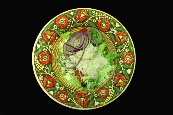 Mixed salad with sheep cheese on a colorful plate, Ukraine