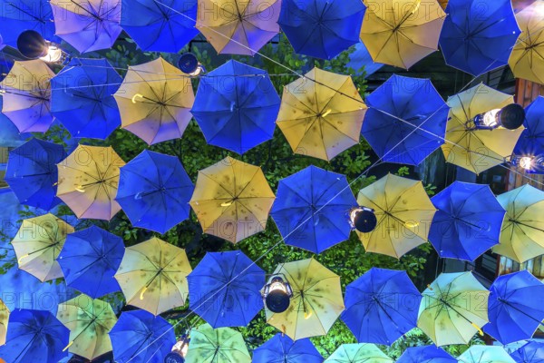 Colourful umbrellas as decoration in a courtyard of a restaurant, Czernowicz, Ukraine