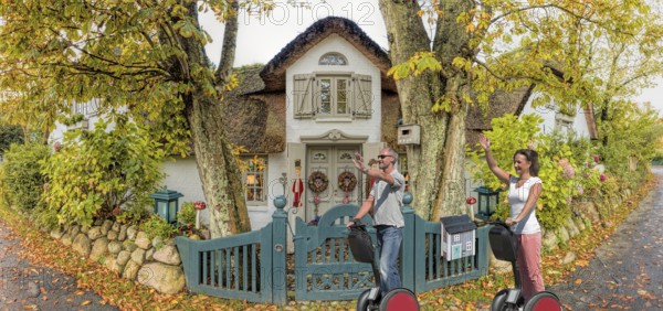 Segway, rider in front of Friesenhaus Panorama Keitum Sylt Germany