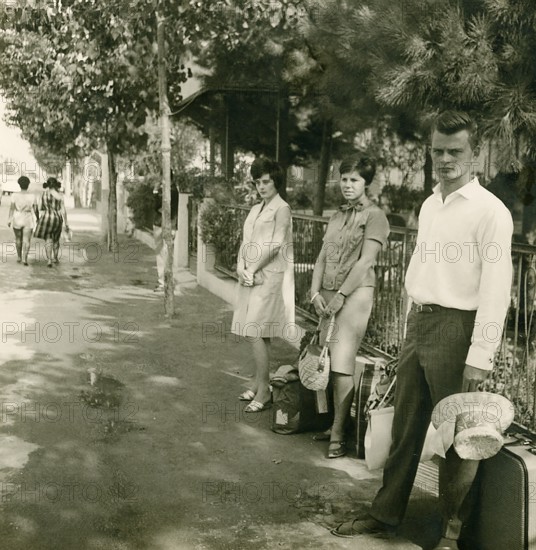 Historical photo summer 1961, tourists in front of returning home at Rimini train station, Rimini, Italy