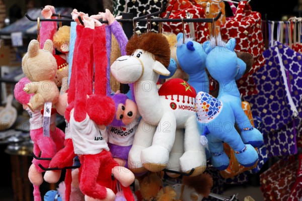 Sales stand with stuffed animals and other souvenirs for tourists at a market in Marrakech, historic old town, Medina, UNESCO World Heritage Site, Morocco