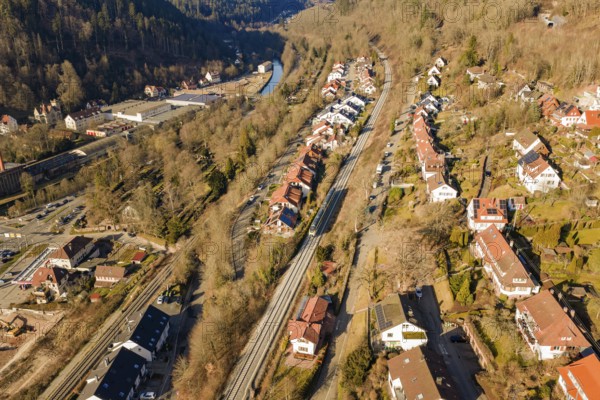 Aerial view of a small village with forest and railroad tracks, test run on the new Hermann-Hesse railway with Siemens Mireo Plus B trains, Calw, Germany