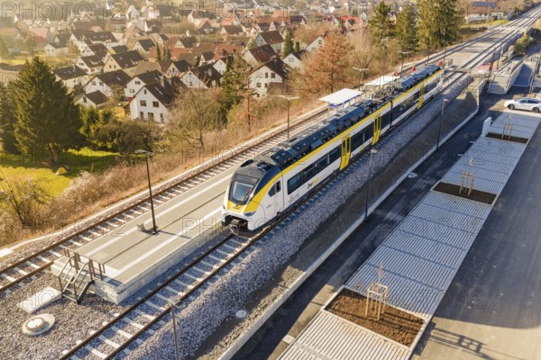 Train at a small train station surrounded by village houses and green countryside, test trip on the new Hermann-Hesse railway with Siemens Mireo Plus B trains, Calw, Germany