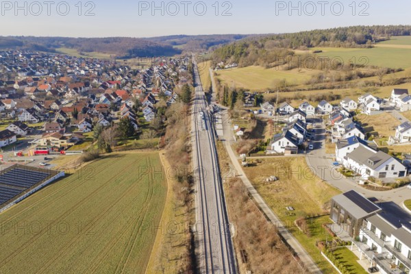Railway tracks cross an extensive landscape with houses and fields, aerial view, test run on the new Hermann Hesse railway with Siemens Mireo Plus B trains, Calw, Germany