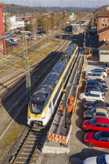 Aerial view of a train station with a passing train and parked cars, test run on the new Hermann-Hesse railway with Siemens Mireo Plus B trains, Calw, Germany